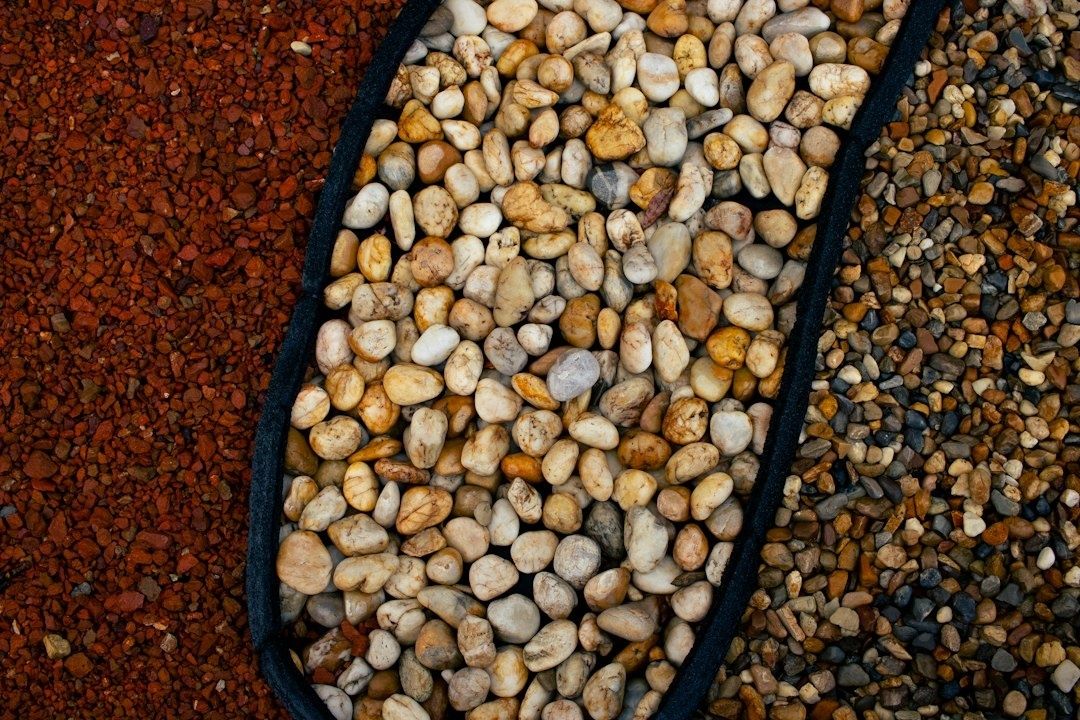 Three sections of aquarium substrate show red, pale, and mixed gravel